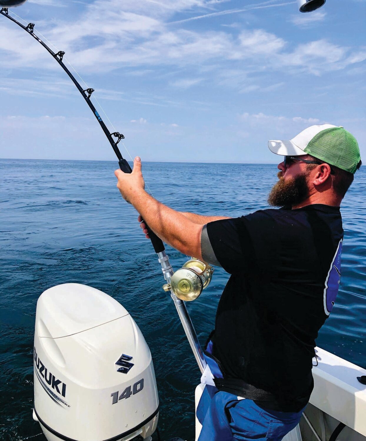 REELING IT IN: Shawn Hayes Costello reels in a thresher shark on his father’s (Greg Vespe) boat southeast of the Sakonnet River.  Vespe’s father and his cousin Stephano from Italy were also part of the crew.